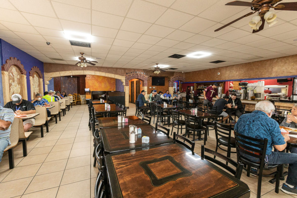 Restaurant interior, guests sitting, eating, drinking